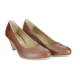 A simple tan vegan leather pump with a small covered heel. Almond toe shape. Beige lining.